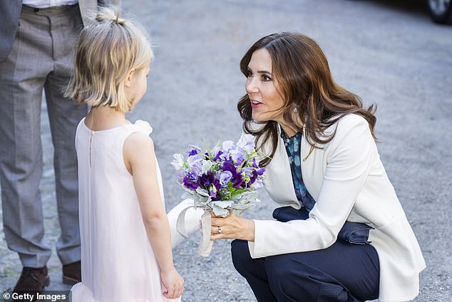 The little girl, named Petra Bruun Funch, delicately extended her bouquet and caught Mary's attention.