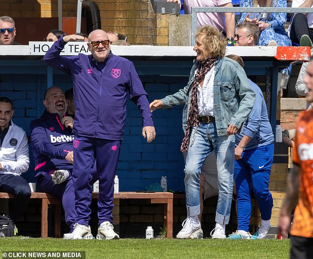 Ray was wearing white sneakers with his bright purple tracksuit.