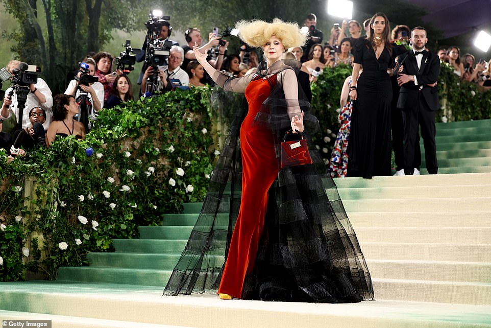 The Game Of Thrones star posed up a storm on the steps of the Met and styled her hair in an eccentric updo.