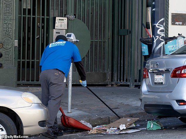 City workers are seen cleaning the streets and removing tents and items belonging to homeless people.