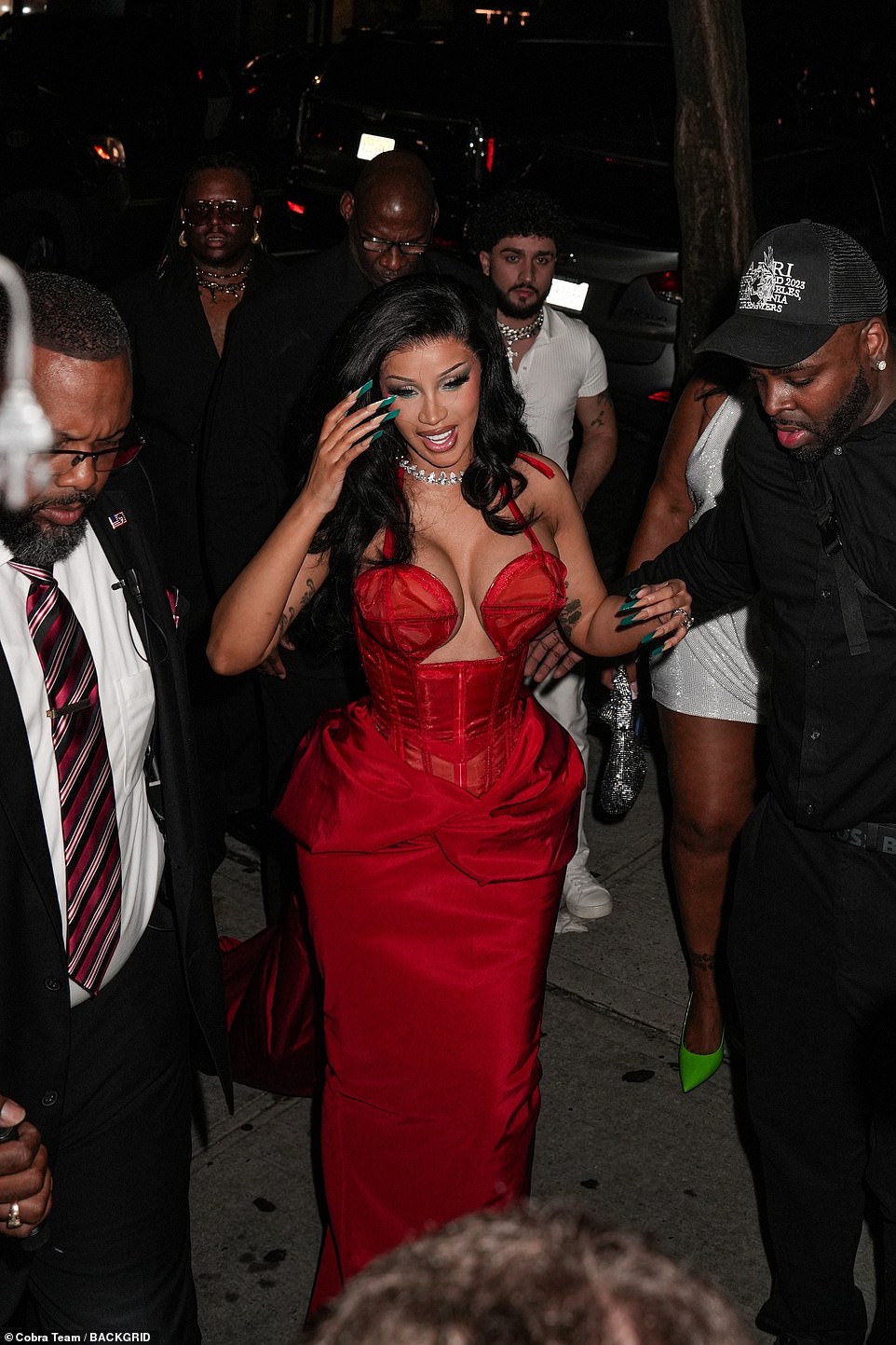 Cardi was helped as she made her way to the venue flanked by several security guards.