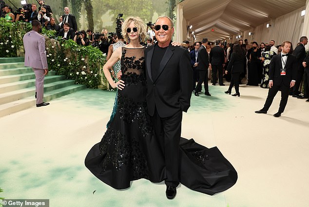 Ryan later wore black aviator sunglasses to pose with Michael Kors, who designed the dress she wore for the night.