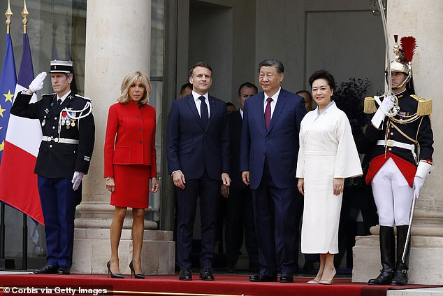 Emmanuel Macron (second from left) and his wife Brigitte (left) pose for photographers alongside Chinese President Xi Jinping and his wife Peng Liyuan, during their two-day state visit.