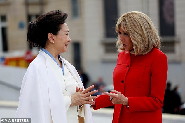 Chinese President Xi Jinping's wife Peng Liyuan and French President Emmanuel Macron's wife Brigitte Macron speak during their visit to the Orsay Museum.