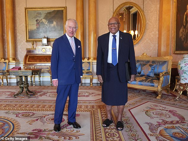 King Charles III greets Fijian Prime Minister Sitiveni Rabuka at Buckingham Palace today