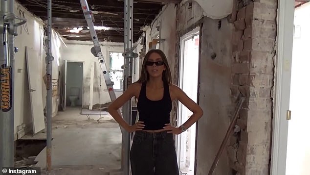 Dressed in a very casual outfit, the former WAG was all smiles as she showed off her new store that is still under construction.