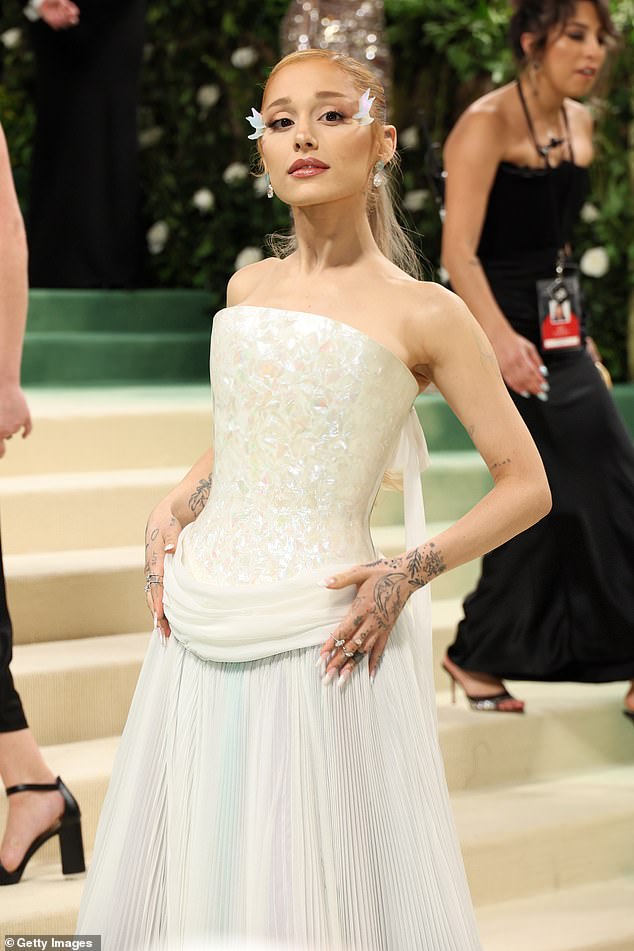 She wore an elegant white Loewe dress with a pleated skirt on the red carpet, but donned a sheer green suit made to measure by John Galliano's Maison Margiela Artisanal for the performance.