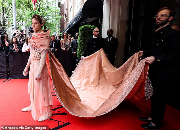 It wasn't just the women who looked ridiculous: Norwegian billionaire salmon fisherman Gustav Magnar Witzoe's chiffon dress had to be held up by assistants.