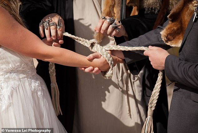 The couple also performed a hand-binding ceremony, which is an ancient Celtic tradition in which their hands are tied by a rope (pictured).