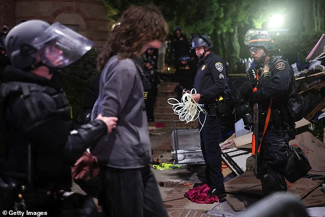 The confrontation was the latest example of unrest following demonstrations of solidarity with Gaza on campuses. Pictured: California Highway Patrol (CHP) officers detain a protester while clearing a pro-Palestinian encampment after dispersal orders were given at UCLA on May 2, 2024.