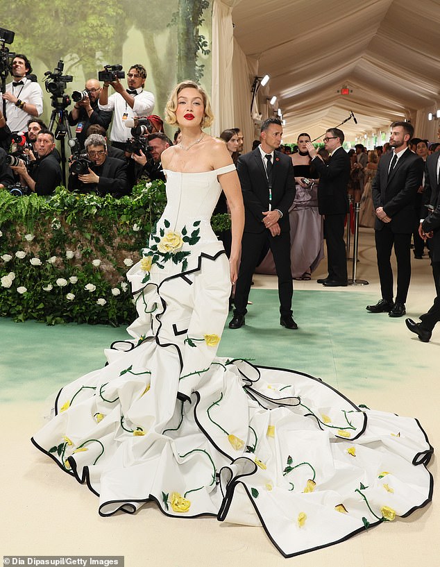 While at the Met Gala, the brunette beauty could have easily bumped into fellow model Gigi Hadid, who attended the fashion Super Bowl in an off-the-shoulder white Thom Browne ballgown covered in yellow rose details.