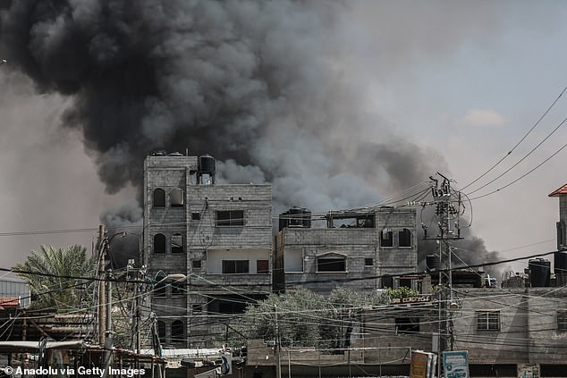 Smoke billows from shopping center following Israeli airstrike east of Rafah, Gaza