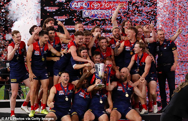 Demons players celebrate after winning AFL top spot during pandemic in 2021