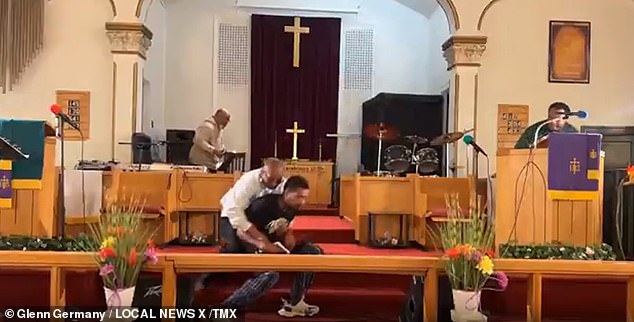 Miraculously, no bullets came out and the shooter was quickly tackled by church deacon Clarence McCallister, who can be seen jumping in front of the camera and tackling the offender to the ground.