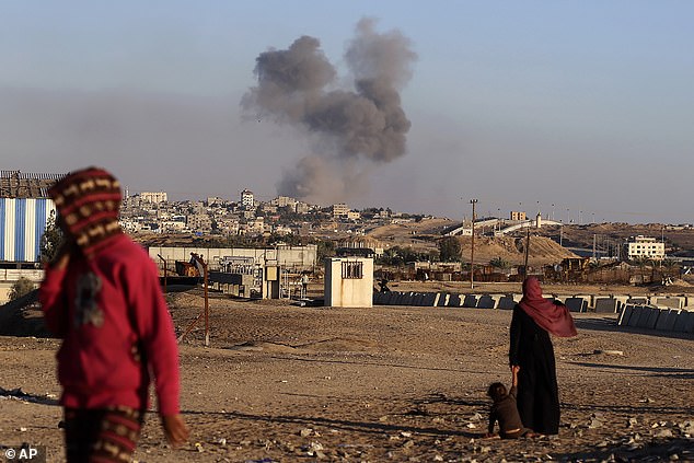 Smoke rises after an Israeli airstrike on buildings near the separation wall between Egypt and Rafah in the southern Gaza Strip.