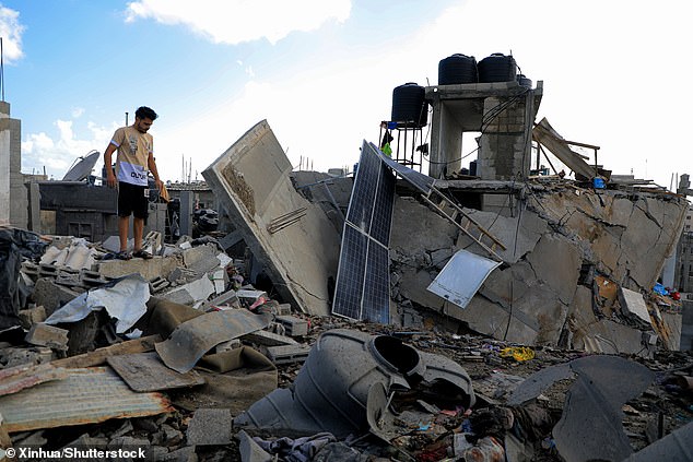 A man lies in the rubble after an Israeli airstrike in the southern Gaza Strip city of Rafah on May 7, 2024.