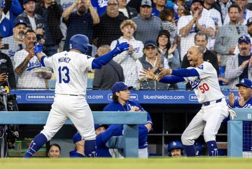 Mookie Betts throws sunflower seeds at Max Muncy after Muncy hits a grand slam in the first inning.