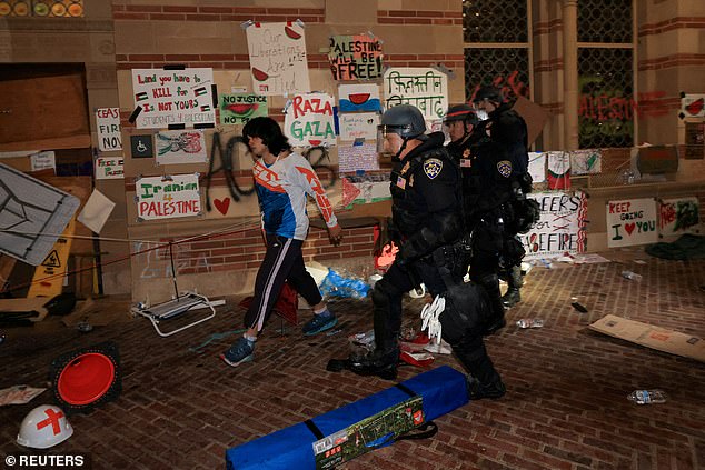 Law enforcement officers walk as they clean up the protest camp in support of Palestinians at the University of California, Los Angeles.