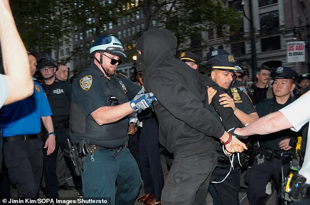 Members of the New York City Police Department arrest a pro-Palestinian protester during a march