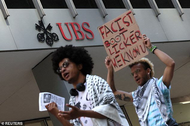 Protesters walk next to the UBS building as Columbia University students protest outside the offices of university administrators.