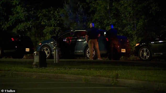 Police have not identified the victims, but said the children, who included two girls and a boy, were of elementary and middle school age. Officers (pictured at the scene) are investigating the case as a murder-suicide.