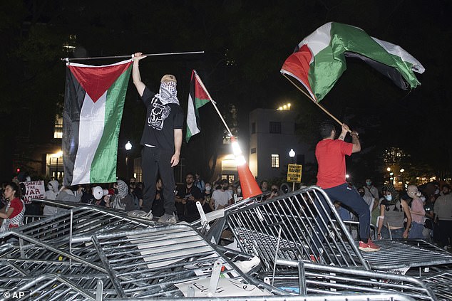 George Washington University is one of several institutions rocked by protests in recent weeks, as seen here on April 29 as protesters tear down police barricades.