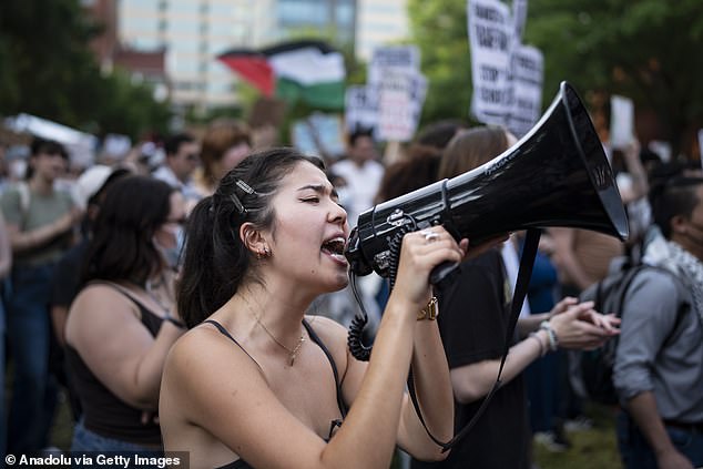 A student is seen Tuesday participating in a pro-Palestine protest on the GWU campus.