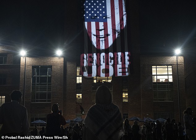 Protesters also projected an image of President Biden's face and an American flag on the side of a building, with the legend: 'Genocide Joe.'