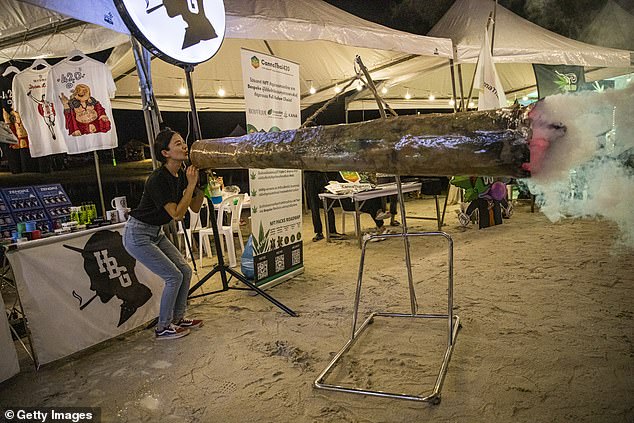 A Thai woman pretends to smoke a giant joint on June 11, 2022 in Nakhon Pathom