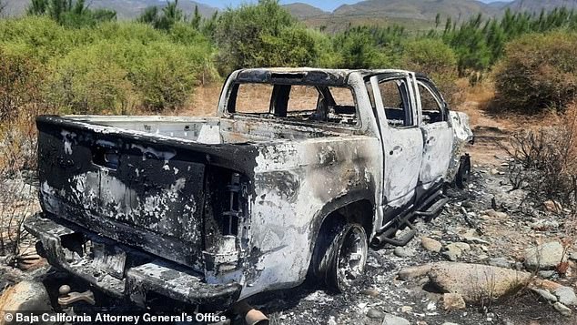 In the photo: The white Chevrolet Colorado pickup truck that was found burned, with the wheels still on the vehicle.