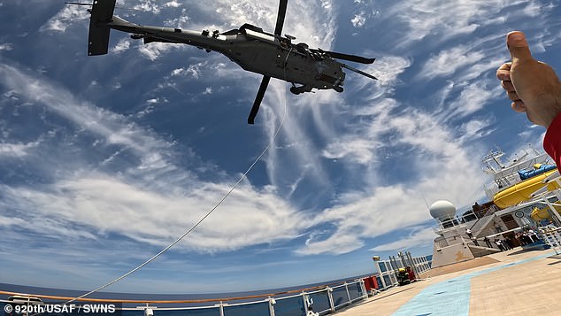 Two helicopters approached the ship to carry out the extraction before the rescuers descended and immediately began preparing the cruise passenger.