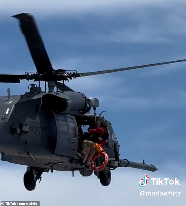 Paratroopers prepare to rescue a passenger from the Carnival Venezia who was in critical condition