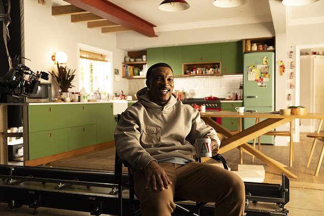 He's dressed in a casual gray sweater at the kitchen table as he tries to get his morning off to a good start.