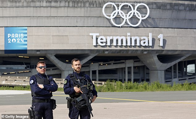 French police officers stand guard outside Terminal 1 at Roissy-Charles de Gaulle airport ahead of this summer's Olympic Games.