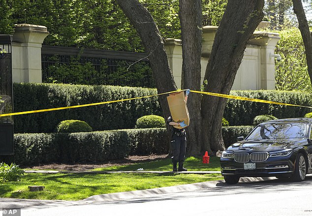 A heavy police presence was seen outside the mansion throughout Tuesday, and police appeared to carry items to and from the house.