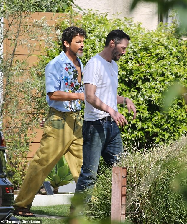 The Matrix alum walked across the set alongside Matt, who was sporting a quirky outfit consisting of a floral-print shirt and yellow jeans.