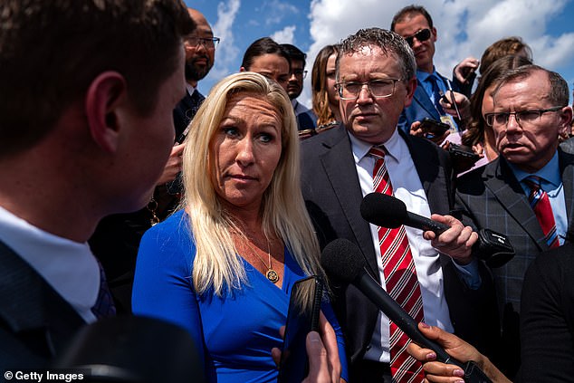 Reps. Marjorie Taylor Greene, left, and Thomas Massie, second from right, have laid out a list of demands for President Mike Johnson, and are now holding off on their move to impeach him.