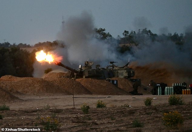 An Israeli self-propelled howitzer fires a projectile towards the Gaza Strip near the Kerem Shalom crossing