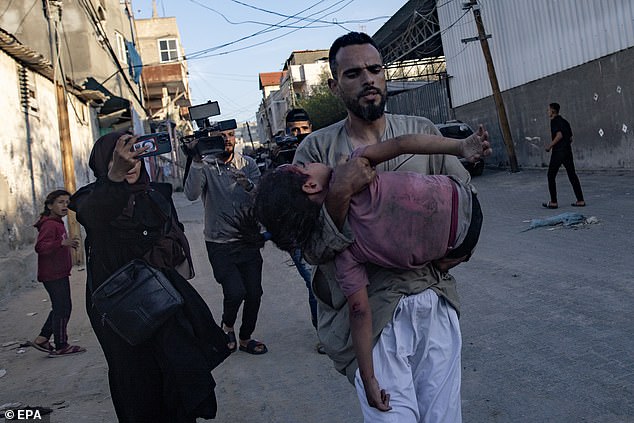 A Palestinian child injured after an Israeli attack is transferred to the Al Kuwaiti hospital in Rafa