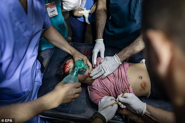 Doctors examine Palestinian boy injured after Israeli attack