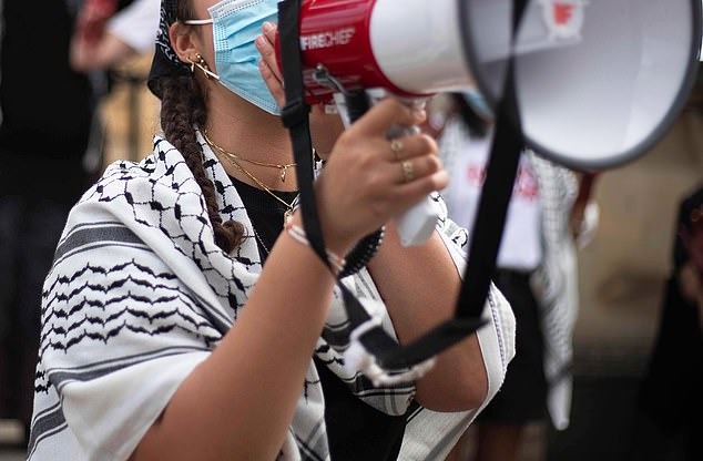 Pro-Palestine student activist participates in a camp in front of the Oxford University Museum of Natural History