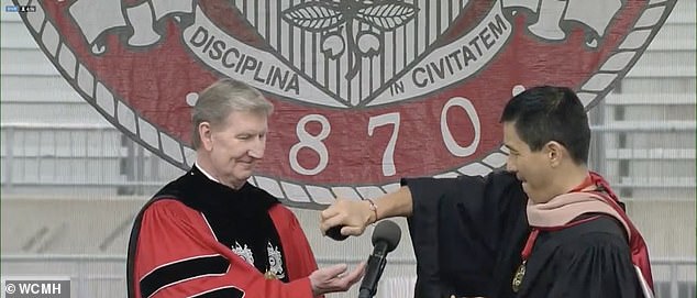 Pictured: Pan presenting a bracelet from his company to OSU President Ted Carter, who promised the student body they would receive them as well.