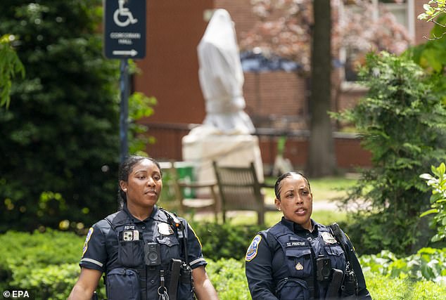 DC police officers stand guard outside the GWU campus after the Gaza solidarity camp was removed early Wednesday morning.