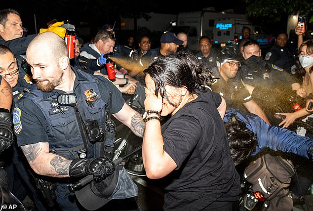 Metropolitan Police Department officers pepper spray protesters at George Washington University