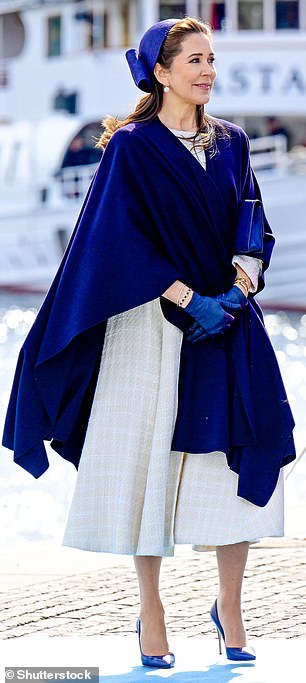 She and Frederik arrived aboard the Royal Yacht Dannebrog and kept warm in a navy shawl and gloves and tied their hair up in a matching hat.