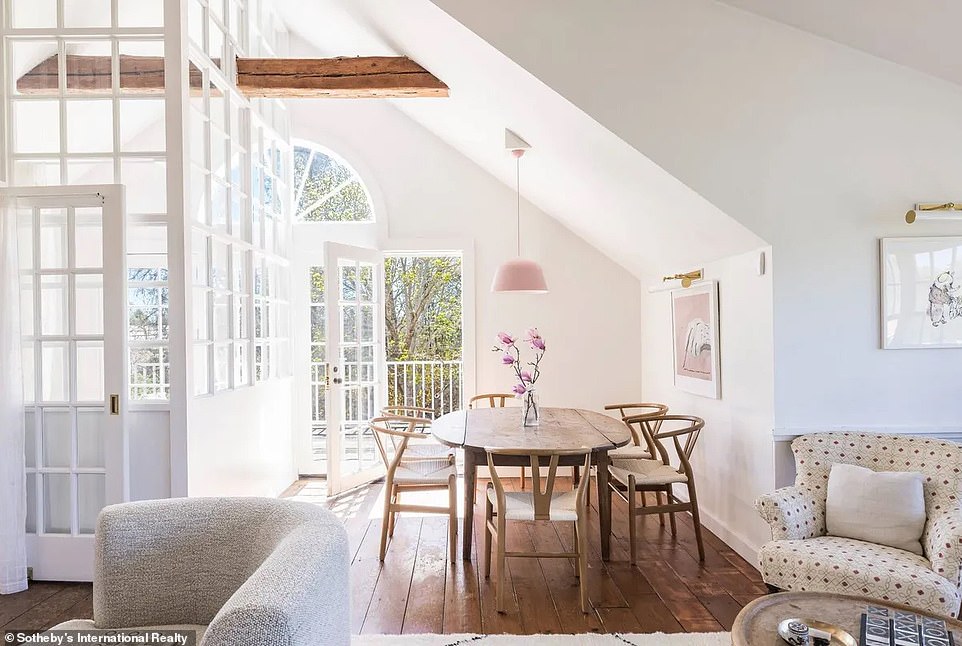 Adjacent to the upstairs living room is a small, elegant dining room that opens onto a balcony, with plenty of windows around to fill the area with natural light.