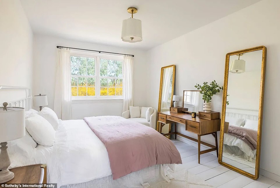 One of the rooms was done almost entirely in white, from the beams to the ceiling fan, floors, walls and window frame.