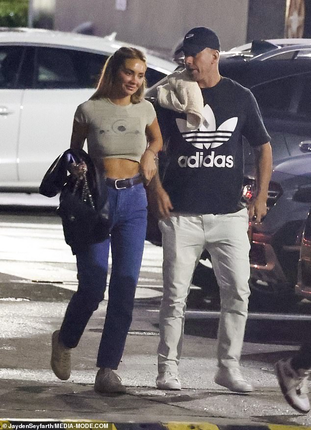 Going braless for the occasion, Rachael showed off her abs in a gray crop top paired with high-waisted jeans.