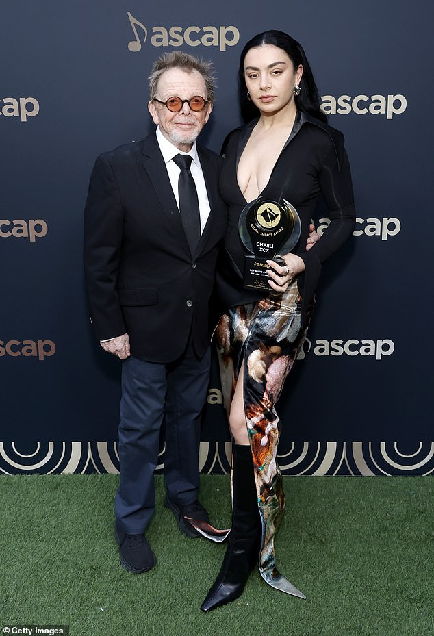 Charli received the coveted ASCAP Global Impact Award for her musical contributions and 'enduring popularity,' as reported by Morning Star; seen with paul williams