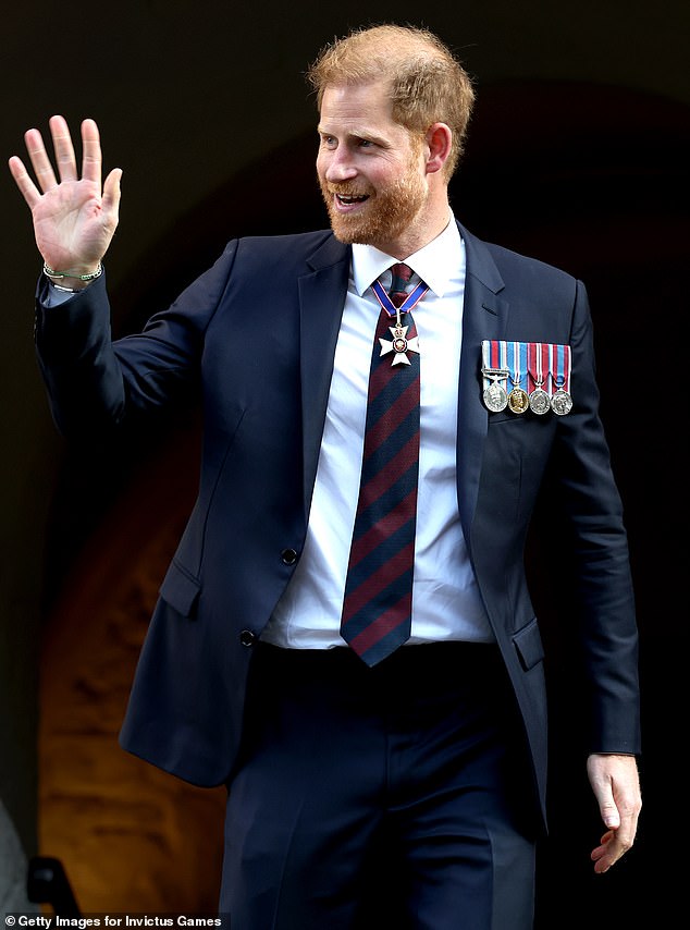 Prince Harry greets supporters outside St Paul's Cathedral in London yesterday.